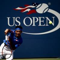Kei Nishikori of Japan serves to Benjamin Becker, of Germany during the first round of the U.S. Open tennis tournament Tuesday in New York. Nishikori, Nara win openers