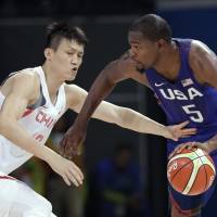 U.S. star Kevin Durant drives past China's Zou Peng during an Olympic men's basketball tournament game on Saturday in Rio de Janeiro. The United States routed China 119-62 in the teams' tourney opener. Durant, U.S. men cruise past China in Rio opener