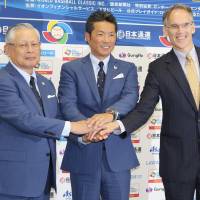 NPB commissioner Katsuhiko Kumazaki (left), Samurai Japan manager Hiroki Kokubo and MLB Vice President for Asia Jim Small pose for a photo at a news conference in Tokyo on Tuesday for the 2017 World Baseball Classic. Tokyo will host two rounds of 2017 WBC