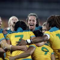 Australia's players celebrate after winning the women's rugby sevens gold-medal match against New Zealand at the Rio Summer Olympics in Rio de Janeiro on Monday. Australia claims women's rugby sevens crown over New Zealand