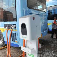 A driver charges an electric bus made by King Long United Automotive Industry at a terminal in the city of Linan, Zhejiang Province, in July. Five companies pocketed millions of dollars in subsidies for buses they never made. Bus subsidies fraud shakes China's electric vehicle industry