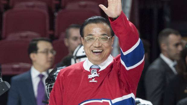 Chinese Premier Li Keqiang, sporting a Montreal Canadiens hockey jersey, waves from center ice at the Bell Centre on Friday in Montreal. Visiting Chinese premier calls for 'win-win' cooperation with Canada
