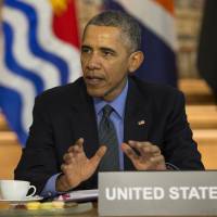 President Barack Obama speaks during a meeting last December with heads of state from small island nations most at risk from the harmful effects of climate change, in Paris. If the nation doesn't do more, the United States probably won't quite meet the dramatic heat-trapping gas reduction goal it promised in last year's Paris agreement to battle climate change, according to a new study. Environment, financial stakes high as key court weighs Obama's legacy climate plan