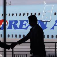 Ray Conner (left), Boeing president and CEO, shakes hands with Walter Cho, Korean Air's executive vice president and chief marketing officer, during a 2015 ceremony in view of a new Boeing 747-8 Intercontinental jet that Korean Air took delivery of in Everett, Washington. Delta Air Lines and Korean Air are taking steps to mend a chilly relationship, announcing an expansion of their partnership Wednesday. Delta, Korean Air rekindle once-frosty partnership