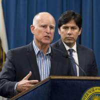 California Gov. Jerry Brown announces Aug. 24 that he will sign a pair of environmental bills approved by the Legislature, during a news conference in Sacramento. At right, is Senate President Pro Tem Kevin de Leon, D-Los Angeles. Brown is set to extend the nation's most ambitious climate change law by another 10 years, charting a new goal to reduce carbon pollution. Brown chose an urban natural park on the edge of downtown Los Angeles as his setting to sign the legislation into law on Thursday. To chagrin of big oil, biz, GOP, California charts cleanest U.S. emissions goals yet