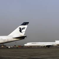 Two passenger planes of Iran's national air carrier, Iran Air, are parked at the Mehrabad Airport in Tehran in 2008. Airbus announced Wednesday that the U.S. government has granted it a license allowing it to sell the first 17 planes involved in a landmark deal with Iran. Most Iranian planes were purchased before the 1979 Islamic Revolution that ousted Shah Mohammad Reza Pahlavi and brought Islamists to power. Airbus, Boeing get U.S. nod to sell aircraft to Iran