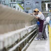 Lixil Group Corp. Inax porcelain toilet bowls are inspected before finishing at the company's Enokido plant in Tokoname, Aichi Prefecture, on Sept. 9. In hot water, bathroom fittings firm Lixil hires outsider to fix pipes