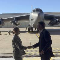 With a B-52 in the background, Defense Secretary Ash Carter greets airmen at Minot Air Force Base, North Dakota, Monday, after giving a speech on nuclear weapons. Carter says the Pentagon is committed to correcting what he calls decades of shortchanging its nuclear forces. Paying to modernize U.S. nuclear arsenal to be left to next president