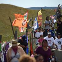 Protestors gather at the blocked entrance to a construction site for the Dakota Access Pipeline to express their opposition to the pipeline, near an encampment where hundreds of people have gathered to join the Standing Rock Sioux Tribe to protest the constructionnear Cannon Ball, North Dakota, Saturday. Sioux clash with bulldozer crew resuming oil pipeline work at sacred site