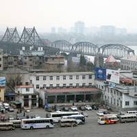Vehicles wait in March at a border checkpoint to cross into North Korea in Dandong in northeastern China's Liaoning province. Chinese authorities are investigating a company that researchers say sold North Korea materials that can be used by its growing nuclear weapons program in a crackdown that reflects Beijing's growing frustration with its isolated neighbor. U.S. slaps China firm with sanctions 'for supporting North Korea's weapons proliferation'