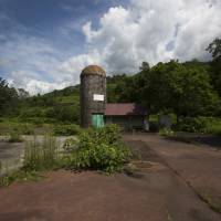 An abandoned building stands at the Coal History Village in the town of Yubari, Hokkaido, on July 21. The bankrupt former mining town is urging its shrunken population to resettle toward its center. Deserted Yubari tries creating new population nucleus in test case for Japan