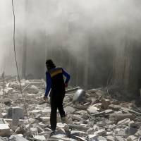 A man walks on the rubble of damaged buildings after an airstrike on the rebel held al-Qaterji neighborhood of Aleppo, Syria, Sunday. Ban cries war crime as Syria, Russia use bunker-buster bombs on Aleppo