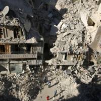 People dig in the rubble in an ongoing search for survivors at a site hit previously by an airstrike in the rebel-held Tariq al-Bab neighborhood of Aleppo, Syria, Monday. 30 doctors left for Aleppo's 300,000 trapped civilians amid 'new hell' brought by Russia, Assad
