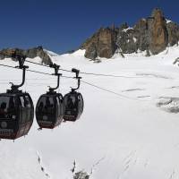 The Panoramic Mont-Blanc cable car linking the Aiguille du Midi peak to the Helbronner peak in Italy, above the seracs and crevasses of the Glacier des Géants (Glacier of the Giants), is seen Aug. 5. About 110 people were stranded Thursday in gondolas above the glaciers of Mont Blanc and had to be rescued by helicopter down into the valley. Mont Blanc cable cars stop, stranding 110 over Alps