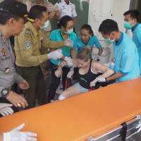 Hospital workers assist a foreign tourist who was injured from an explosion on a ferry boat traveling from the island of Bali to Lombok, at Penta Medika Hospital in Bali, Indonesia, on Thursday. Bali tourist boat blast kills two foreigners, injures 18