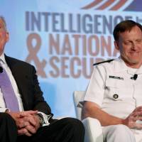 Central Intelligence Agency (CIA) Director John Brennan and National Security Agency (NSA) Director Adm. Michael Rogers participate in a session at the third annual Intelligence and National Security Summit in Washington Thursday. CIA chief Brennan warns Russian hackers are very capable