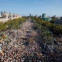 People hold Catalan separatist flags known as Esteladas during a gathering to mark the Catalonia day Diada in central Barcelona, Spain, Sunday. Half a million seen turning out for Catalan separatist rally in Barcelona