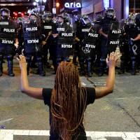 A protester faces police in riot gear in Charlotte, North Carolina, on Wednesday. Unrest flares anew in U.S. city after police shooting