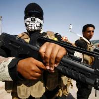 Members of the Popular Mobilization Units supporting the government forces stand on the outskirts of the holy Iraqi city of Najaf on Saturday as take part in a military parade from Karbala to Najaf to review the military equipment to be used in the operation to re-take the city of Mosul from the Islamic State (IS) group. Islamic State bent on using chemical arms when Mosul invasion comes: Pentagon