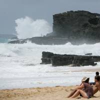 Waves generated by Hurricane Lester crash against the cliffs at Sandys Beach park in Honolulu on Saturday. There is increasing evidence that warmer seas due to human-caused climate change is increasing the intensity of hurricanes and typhoons. Climate commitment by U.S. and China hailed as signaling hopeful era