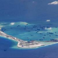 Chinese dredging vessels are seen in the waters around Mischief Reef in the disputed Spratly Islands of the South China Sea in this still image from video taken by a U.S. Navy P-8A Poseidon surveillance aircraft and provided in May 2015. Chinese coast guard involved in most South China Sea clashes, research shows
