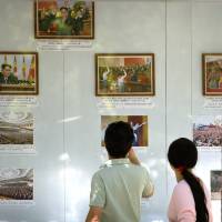 People look at a display of photos outside the North Korean Embassy in Beijing on Friday after North Korea conducted a higher-level nuclear warhead test. China responds strongly to North Korean nuclear test but is unlikely to do much