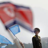 A North Korean soldier stands guard during an aerial display Saturday in Wonsan, North Korea. China upset as U.S. slaps sanctions on firm tied to North Korean nuclear program
