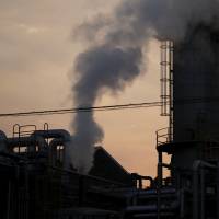 Steam rises from a chemical plant at dusk in the Keihin industrial area in Kawasaki. Scientists say world could pass key temperature-rise mark in decade