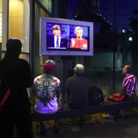 People watch the first debate between Hillary Clinton and Donald Trump at an office building in Hollywood on Monday. Trump-Clinton debate was the most-watched ever