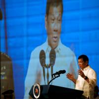 Philippines President Rodrigo Duterte speaks to members of the Filipino community in Jakarta on Friday. He said the same day that he did not curse U.S. President Barack Obama. Duterte tells Obama he never cursed him