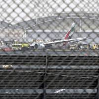 A damaged Boeing 777 is seen Aug. 3 at the Dubai airport after it crashed. A preliminary report into last month's Emirates airliner crash in Dubai has found that the pilot attempted to abort the landing after an initial touchdown and that the plane ultimately hit the runway as its landing gear was retracting. Gear retracting when Emirates jet crashed; go-around thrust seen coming too late