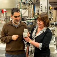 Allen Nutman of the University of Woollongong and Vickie Bennet of the Australian National University hold a specimen of 3.7 billion-year-old fossils found in Greenland in Canberra Aug. 23. Global warming exposes fossils in Greenland from time Earth was like Mars