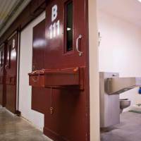 This file photo taken on April 8, 2014, m.ade during an escorted visit and reviewed by the U.S military shows the corridor and the cell doors of the Camp 5 detention facility at the U.S. Naval Station in Guantanamo Bay, Cuba. The US military has closed Camp 5, an official said Thursday, as the controversial military prison's population continues to shrink. U.S. closes Guantanamo maximum security unit but five tied to 9/11 plot still held