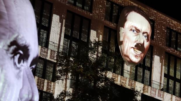 The faces of Adolf Hitler (right) and Joseph Goebbels, are projected onto 3-D canvases as part of an art installation during a rehearsal for the Berlin Leuchtet festival in Berlin Thursday. Artist's huge Hitler apparition on Berlin building prompts call for cops