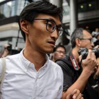 New anti-establishment lawmaker Eddie Chu, who has received death threats from triad gangs after taking on pro-establishment rural strongmen with alleged criminal links, arrives to make a report at Wanchai police station in Hong Kong on Sept. 8. Hong Kong begins explosive political chapter as former protesters enter legislature