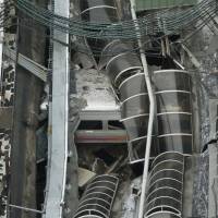 A derailed New Jersey Transit train lies under a collapsed station roof after crashing on Thursday in Hoboken. New Jersey train crash raises PTC and many other familiar safety issues