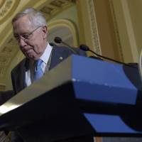 Senate Minority Leader Sen. Harry Reid, accompanied by Sen. Charles Schumer, walks away from the podium following a news conference on Capitol Hill in Washington Wednesday. House hawks want to impeach IRS chief over tea party probes but face poll backlash