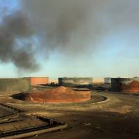 Smoke billows in January from a petroleum storage tank after a fire was extinguished following fighting at Al-Sidra oil terminal, near Ras Lanuf in the so-called oil crescent along Libya's northern coast. Forces loyal to Gen. Khalifa Haftar on Sunday said they had seized the Al-Sidra and Ras Lanuf oil export terminals as the Tripoli-based Government of National Accord (GNA) struggles to assert its authority over the oil-rich country. Rival Libyan leader's forces seize key oil ports, casting doubt on output
