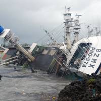 A fishing boat that overturned during Typhoon Meranti lies in the harbor in the community of Sizihwan in the Taiwanese municipality of Kaohsiung on Thursday. Typhoon Meranti leaves 16 dead or missing in China