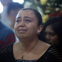 A woman grieves Sept. 21 during the funeral Mass for slain Rev. Jose Alfredo Suarez de la Cruz, who was found bound and shot to death alongside another priest, inside Our Lady of Asuncion Church in his hometown Paso Blanco, Veracruz state, Mexico. Locals have gotten accustomed to hearing about grisly murders. The city of 195,000, has recorded 41 killings in the first eight months of this year, more than three times the toll for all of 2015. Third abducted priest also found slain in western Mexico