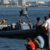 Egyptian rescue workers arrive on a boat carrying bodies of migrants in Rosetta, Egypt, on Friday after a boat carrying migrants capsized in the Mediterranean. 162 bodies retrieved after migrant boat capsizes off Egypt