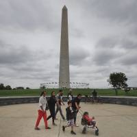 Visitors walks past the Washington Monument on the National Mall in Washington Monday. Elevator trouble closes the Washington Monument indefinitely, the National Park Service says. Washington Monument closed indefinitely till lift gets put right