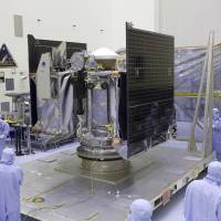 This May 21 photo provided by NASA shows the OSIRIS-REx spacecraft inside a servicing facility at Kennedy Space Center in Florida after arriving from Lockheed Martin's facility near Denver. Its mission, planned for launch on Thursday aims to return a sample of the asteroid Bennu to Earth for study as well as return detailed information about the asteroid and its trajectory. NASA set to chase down asteroid Bennu, grab some gravel to bring home