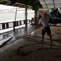 A man shovels mud inside a restaurant damaged by Hurricane Newton in Cabo San Lucas, Mexico, Tuesday. The U.S. National Hurricane Center says Newton's winds Tuesday morning were around 90 mph (150 kph) and the storm is expected to still be a hurricane when it makes its second landfall on the northwest coast of mainland Mexico early Wednesday. Hurricane Newton buffets Baja but Los Cabos resorts spared major damage