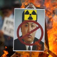 A poster featuring North Korean leader Kim Jong Un is set on fire during an anti-North Korea rally in central Seoul on Saturday. South Korean plan to kill Kim likely to reinforce North's view that nukes are needed: experts