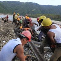 Workers repair the flood-damaged train tracks between SinJon and KanPhyong train stations in North Korea's North Hamgyong Province, on Friday. North Korea rushes to get supplies, shelter to Lionrock flood victims