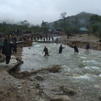 A Sept. 8, 2016, file photo shows mobilized villagers attempting to repair roads from Chongjing to Musan and Yonsa counties in North Hamyong province. North Korea calls floods 'worst disaster' since WWII