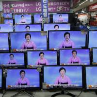 TV screens show a North Korean newscaster reading a statement from the North's Nuclear Weapons Institute during a news program at the Yongsan Electronic Market in Seoul on Friday. North Korea ready for another nuclear test, report says