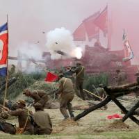 South Korean soldiers play both the roles of South Korean forces and invading North Korean soldiers during a re-enactment of the 1950 battle of Nakdong River to mark the 66th anniversary at the town of Waegwan in Chilgok County on Thursday. Questioning the stereotypes about North Korea's fragilty