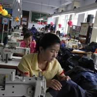 Seamstresses stitch together clothing at a factory in the Rason Special Economic Zone in North Korea on July 23. Trade zone bustle exposes limits of North Korea sanctions